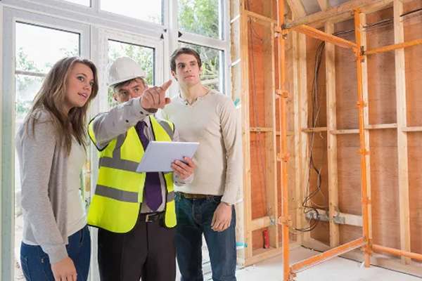 Contractor with couple in unfinished house